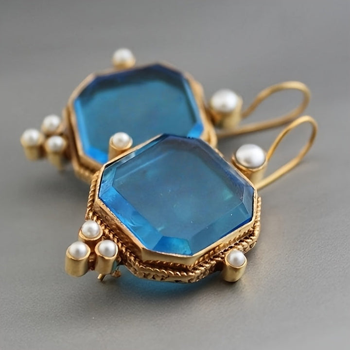 Pendientes colgantes vintage con acentos de cristal azul y flor de lis