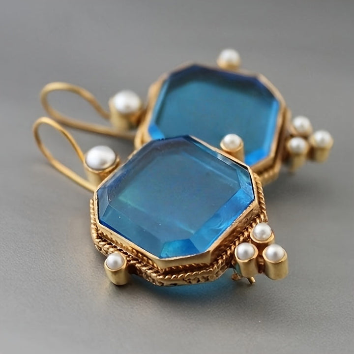 Pendientes colgantes vintage con acentos de cristal azul y flor de lis