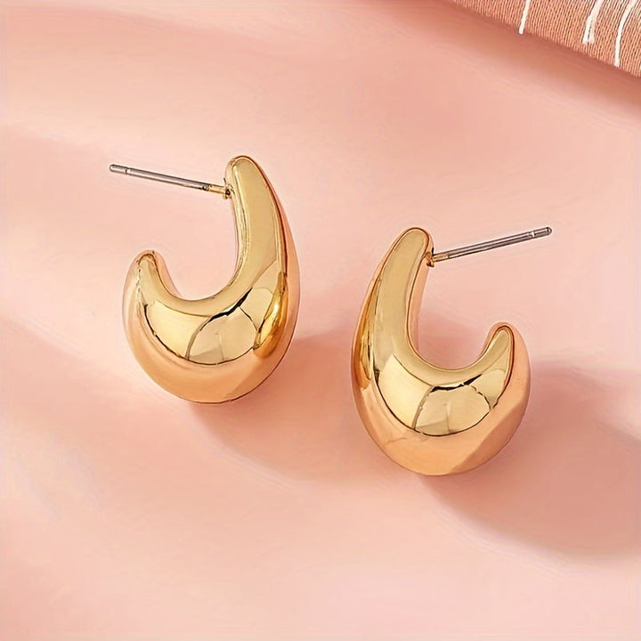 Pendientes minimalistas dorados en forma de C escultórica
