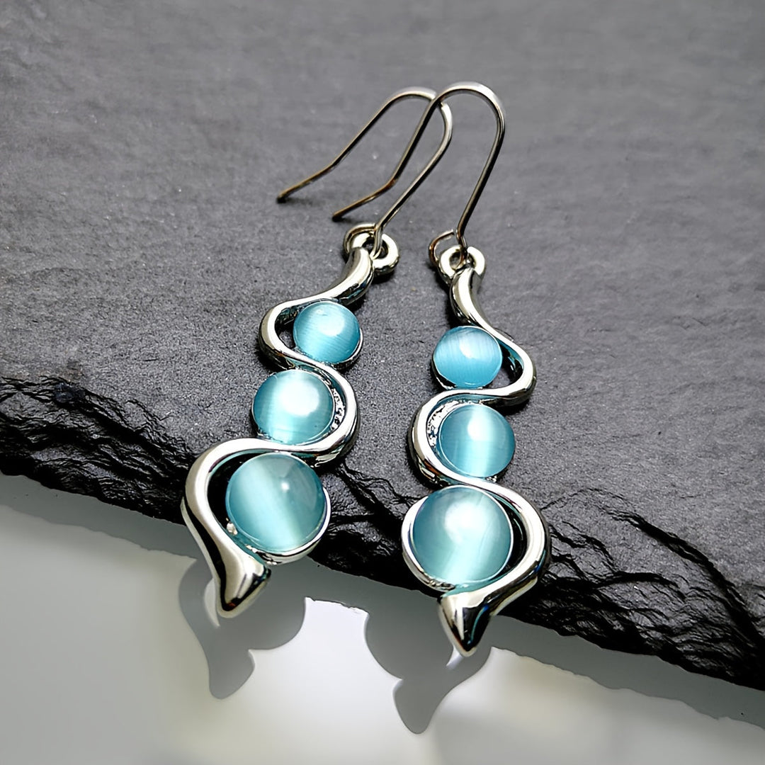 Pendientes colgantes espirales chapados en plata con piedra luna