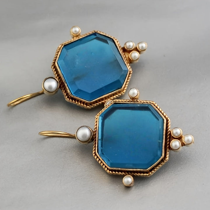 Pendientes colgantes vintage con acentos de cristal azul y flor de lis