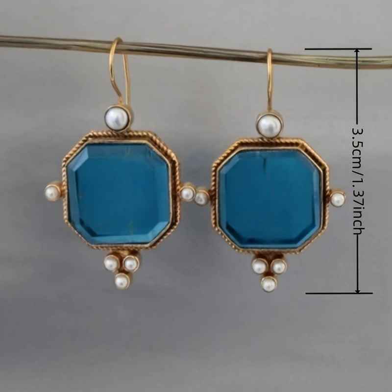Pendientes colgantes vintage con acentos de cristal azul y flor de lis