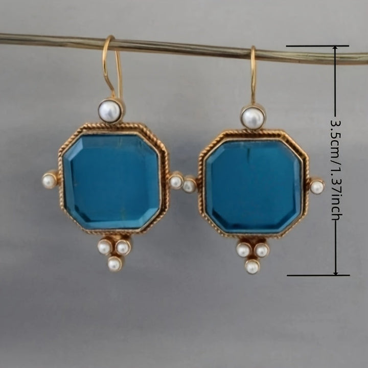 Pendientes colgantes vintage con acentos de cristal azul y flor de lis