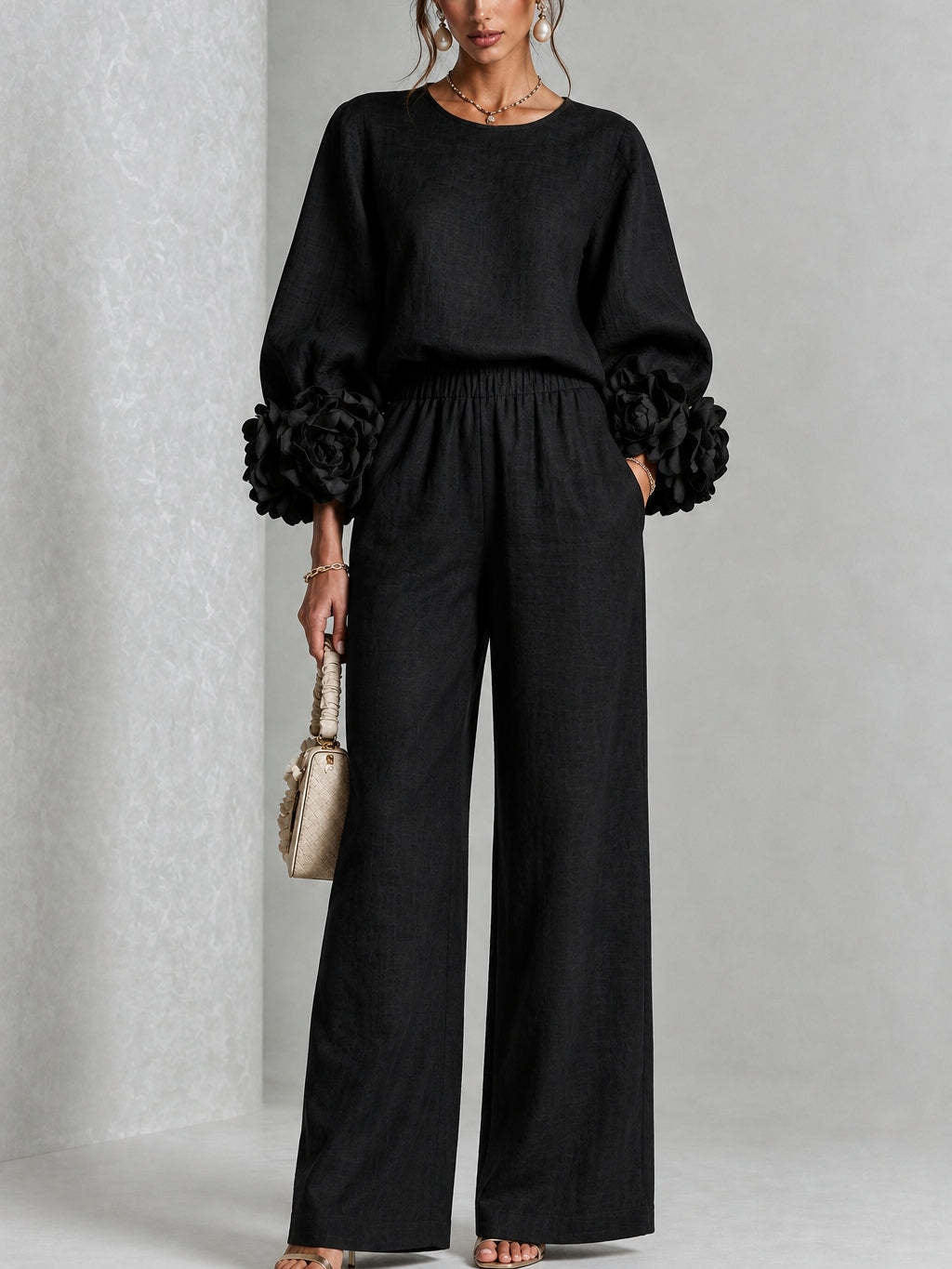 Black ruffle cuff knit top and wide leg pants, standing front view